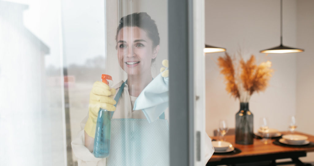 cleaning-windows-woman-apron-cleaning-windows-looking-involved-1024x541