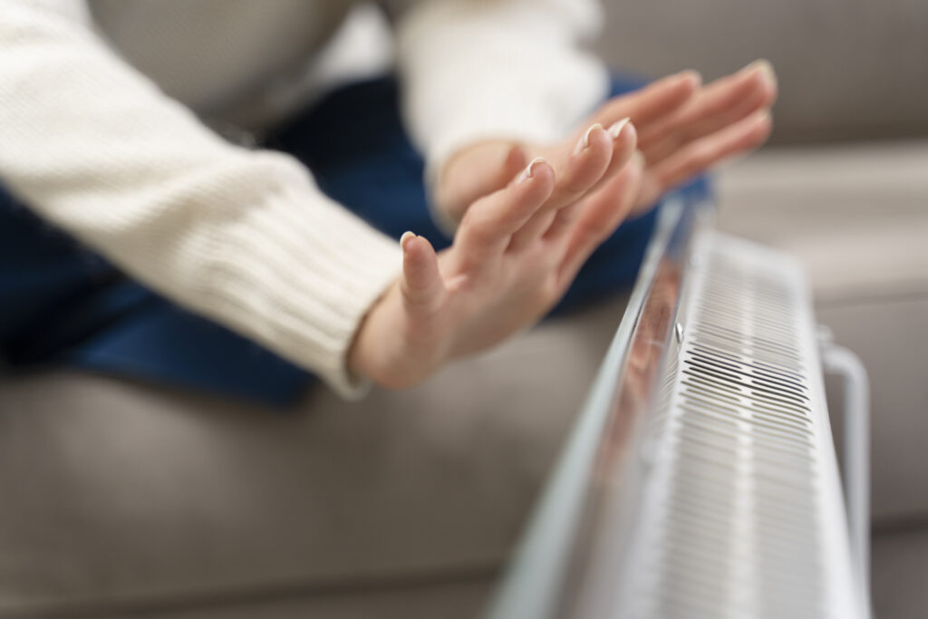 close-up-hands-warming-up-near-heater-1024x683